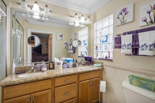 bathroom featuring toilet, crown molding, tile walls, and vanity