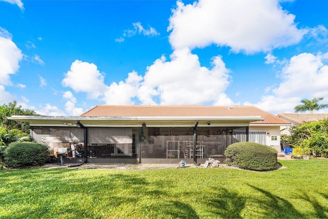 back of house with a yard and a sunroom