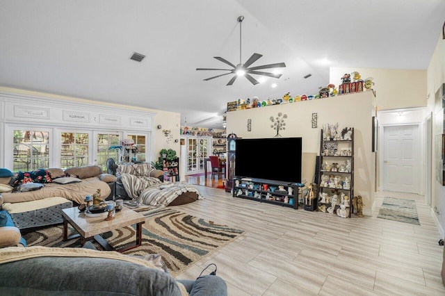 living room featuring ceiling fan and lofted ceiling