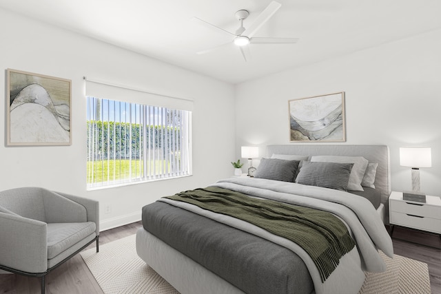 bedroom featuring dark wood-style floors, ceiling fan, and baseboards