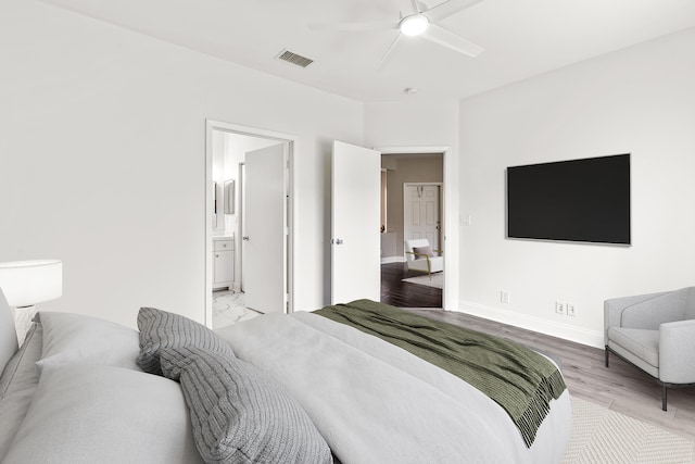 bedroom featuring visible vents, baseboards, a ceiling fan, connected bathroom, and light wood-style flooring