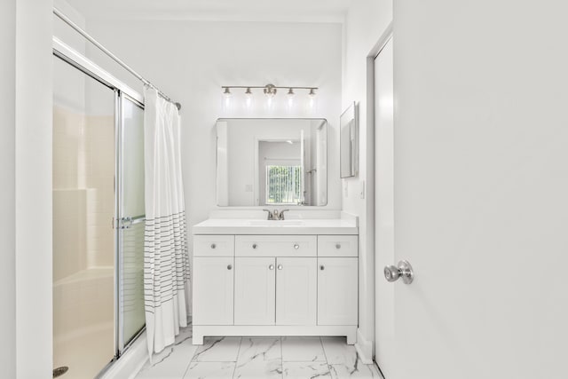 full bathroom featuring a stall shower, marble finish floor, and vanity