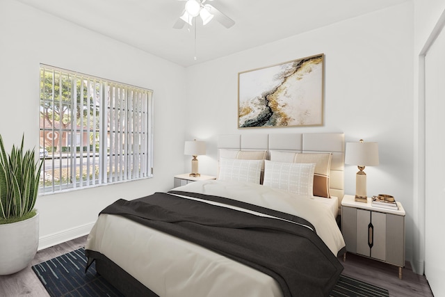 bedroom with dark wood-style floors and baseboards