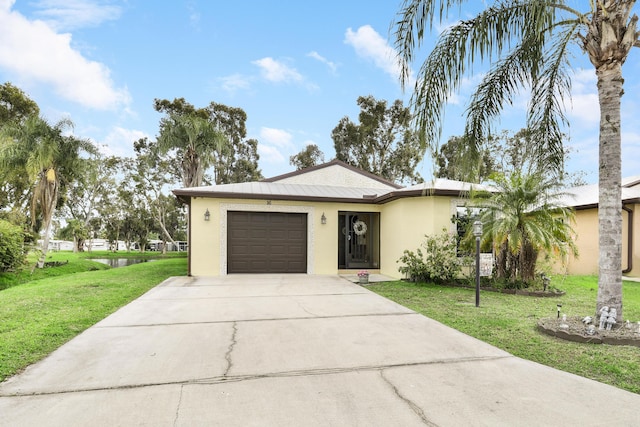 ranch-style house featuring a garage, a front yard, concrete driveway, and stucco siding