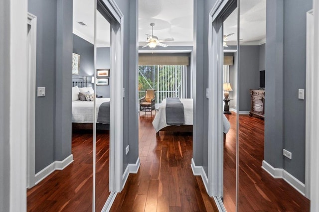 hall featuring crown molding and dark wood-type flooring