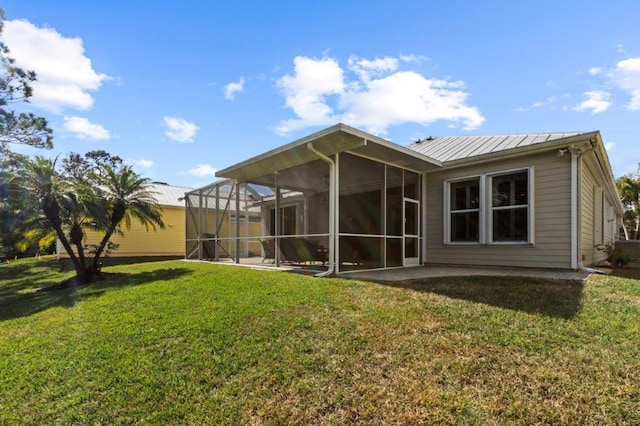 back of property featuring a patio and a yard