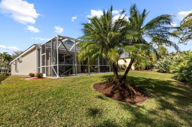 rear view of property featuring a yard and glass enclosure