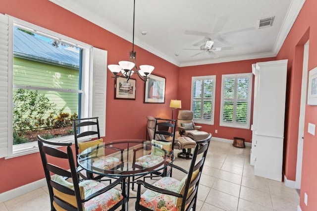 dining room with crown molding, ceiling fan with notable chandelier, and light tile patterned floors