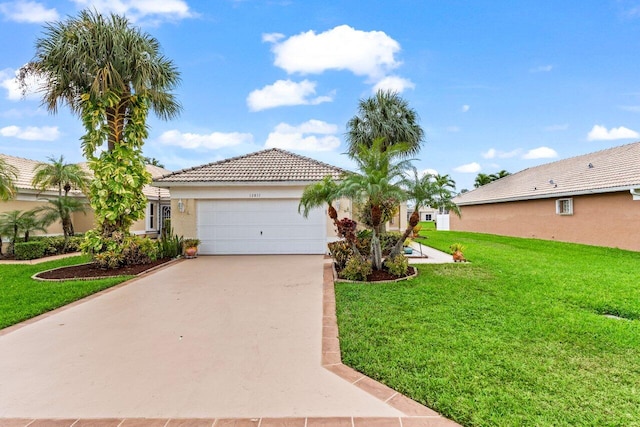 view of front of house featuring a front lawn and a garage