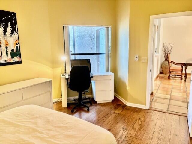 22663 Meridiana Dr, Boca Raton, FL 33433 - bedroom featuring baseboards and wood finished floors