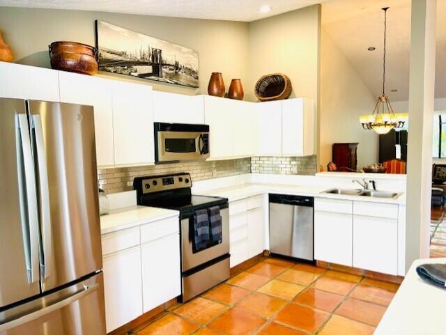 22663 Meridiana Dr, Boca Raton, FL 33433 - kitchen featuring light countertops, backsplash, appliances with stainless steel finishes, and a sink