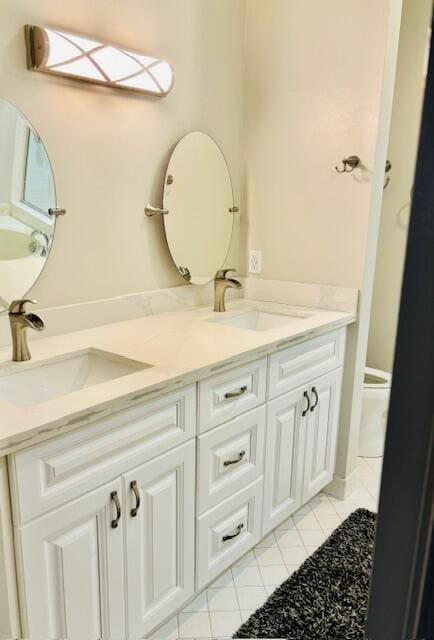 22663 Meridiana Dr, Boca Raton, FL 33433 - bathroom featuring tile patterned flooring, double vanity, toilet, and a sink