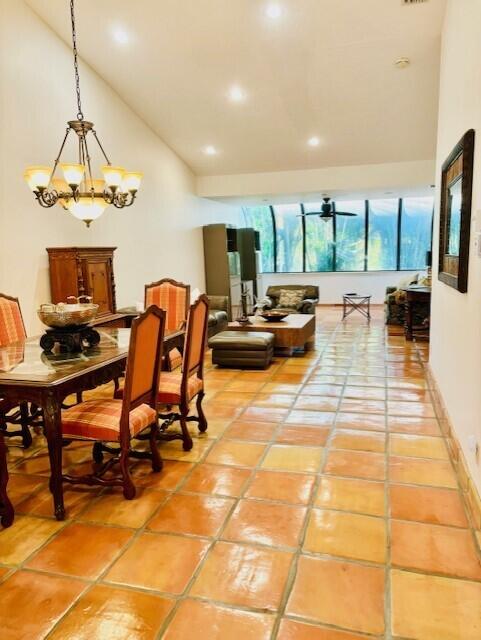 22663 Meridiana Dr, Boca Raton, FL 33433 - dining area with high vaulted ceiling, light tile patterned flooring, recessed lighting, and a chandelier
