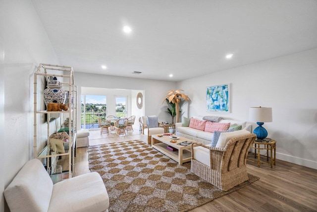 living area with recessed lighting, wood finished floors, and baseboards