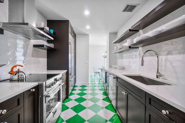 kitchen with visible vents, appliances with stainless steel finishes, wall chimney range hood, open shelves, and a sink