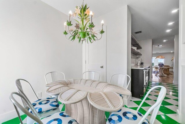 dining area featuring recessed lighting, visible vents, and a notable chandelier