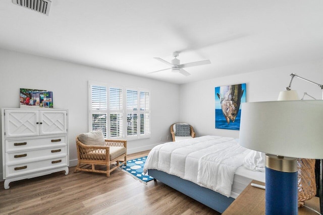 bedroom with visible vents, ceiling fan, and wood finished floors