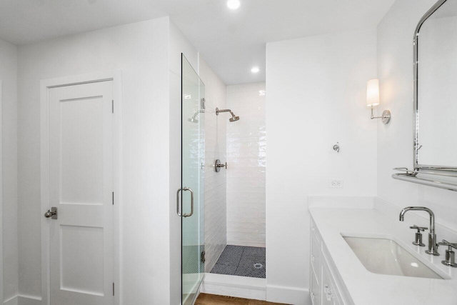 full bath with baseboards, a shower stall, vanity, and recessed lighting