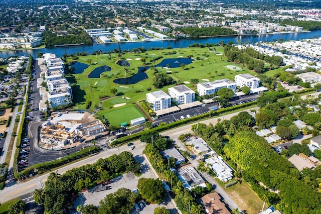 drone / aerial view with golf course view and a water view