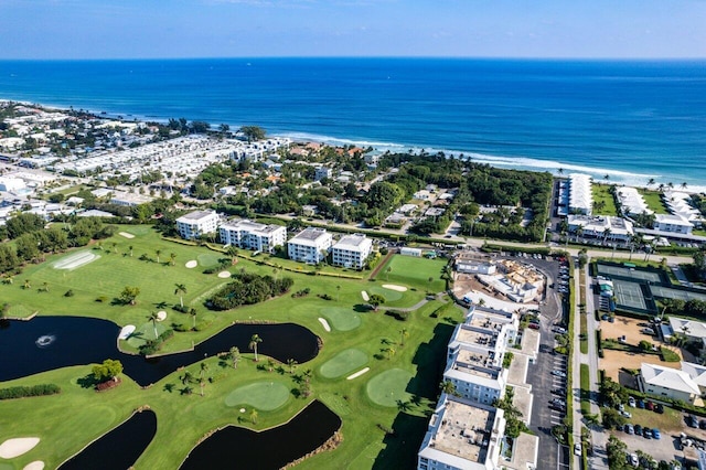 birds eye view of property with a water view and golf course view