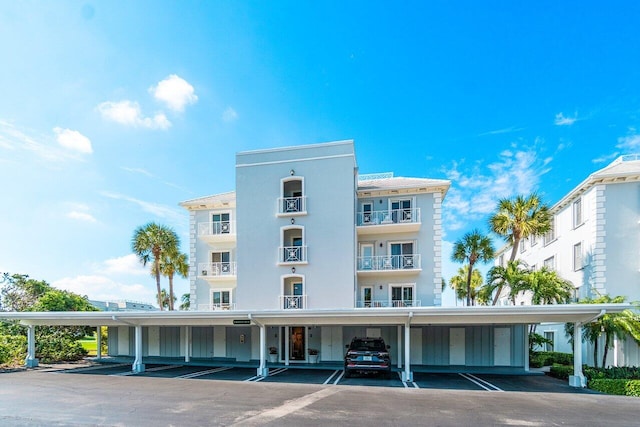 view of building exterior featuring covered parking