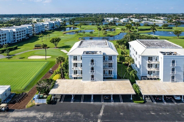 birds eye view of property with view of golf course and a water view