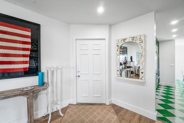 entryway featuring baseboards, wood finished floors, and recessed lighting