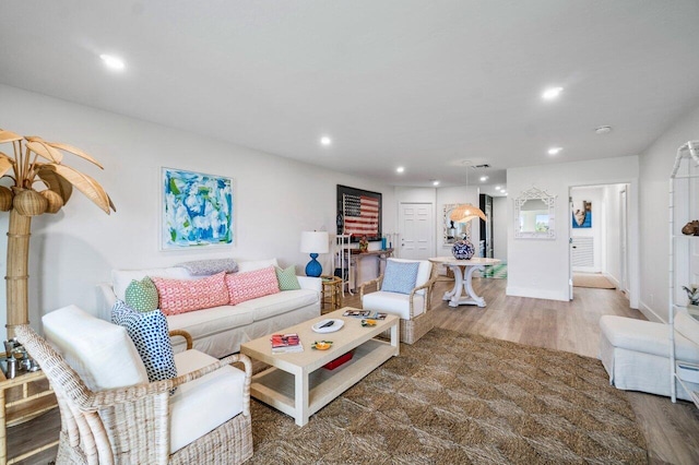 living room with baseboards, dark wood finished floors, and recessed lighting