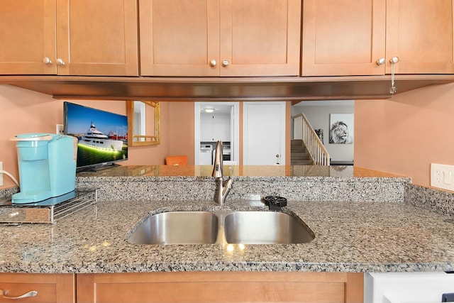 kitchen with sink and light stone counters