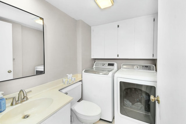 clothes washing area featuring separate washer and dryer and sink