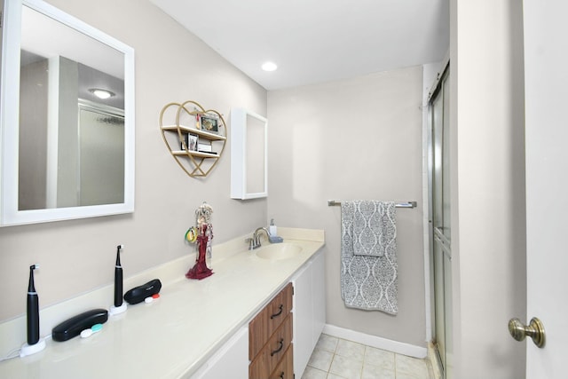 bathroom with vanity, tile patterned flooring, and a shower with door