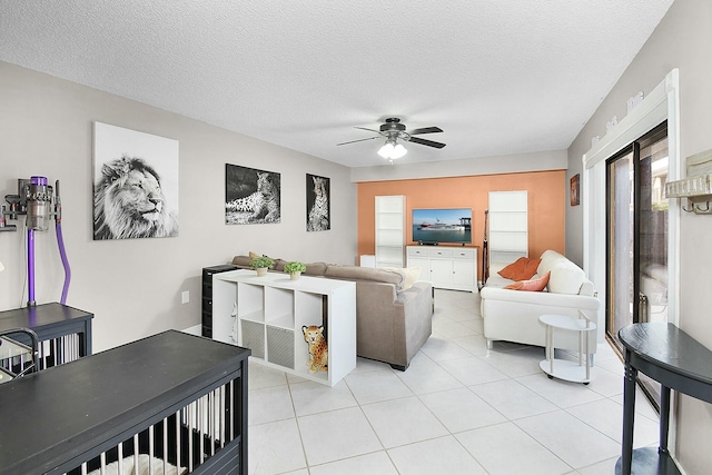 living room with light tile patterned floors, a textured ceiling, and ceiling fan