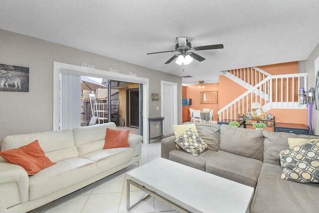 tiled living room featuring ceiling fan and a textured ceiling