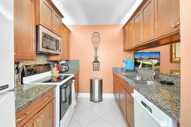 kitchen featuring electric stove, sink, dishwasher, and stone countertops