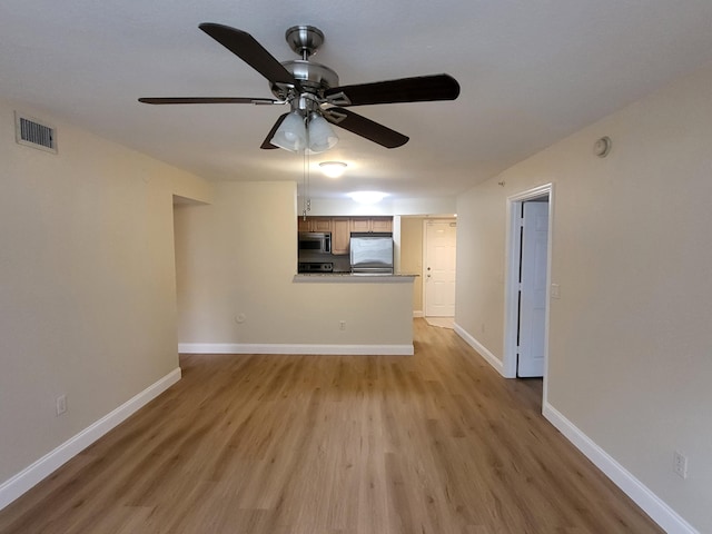 unfurnished living room with ceiling fan and light wood-type flooring