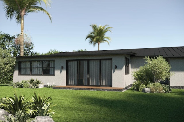 219 32nd St, West Palm Beach, FL 33407 - back of property featuring stucco siding, a yard, and a standing seam roof