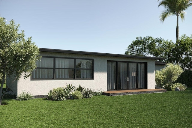 219 32nd St, West Palm Beach, FL 33407 - rear view of property featuring stucco siding and a lawn