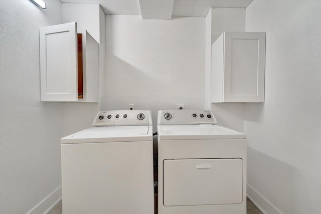 laundry area with cabinets and independent washer and dryer