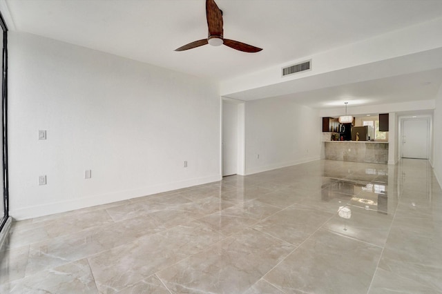 unfurnished living room featuring ceiling fan