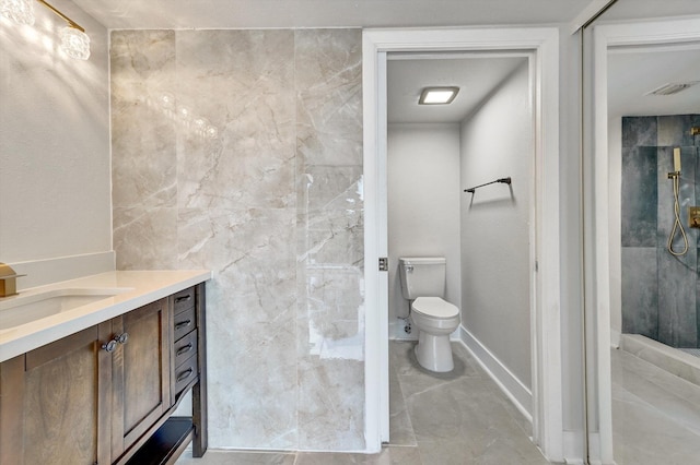 bathroom with vanity, toilet, and a tile shower