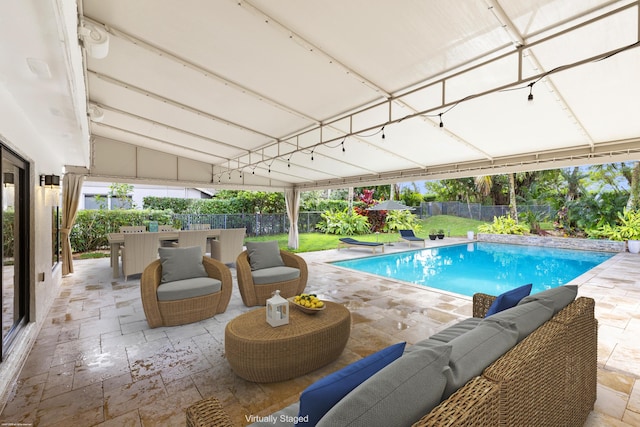 view of pool with an outdoor living space, a patio area, a fenced backyard, and a fenced in pool