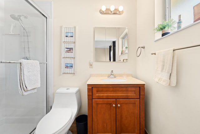 full bathroom with a stall shower, vanity, and toilet