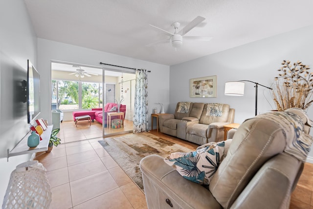 living room with light tile patterned floors and ceiling fan