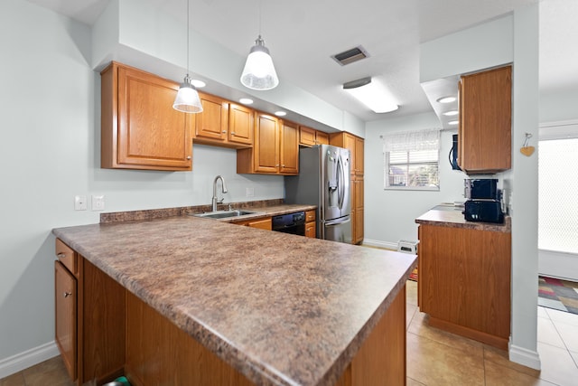 kitchen featuring a peninsula, a sink, and brown cabinets