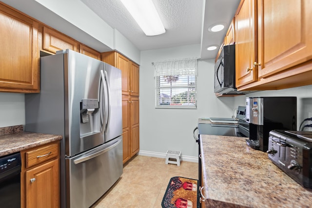 kitchen featuring light tile patterned flooring, black appliances, a textured ceiling, light stone countertops, and baseboards