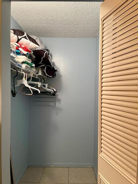 spacious closet featuring light tile patterned floors