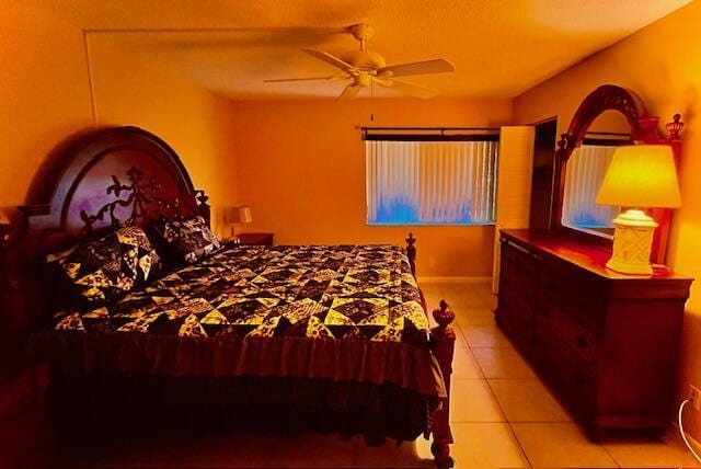 bedroom with a ceiling fan and light tile patterned floors