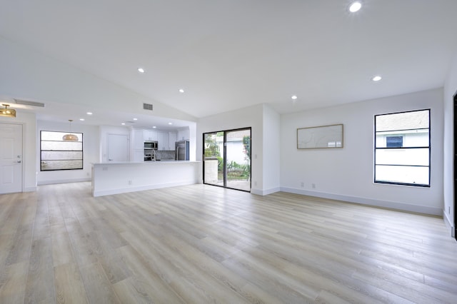 unfurnished living room featuring light wood finished floors, baseboards, visible vents, high vaulted ceiling, and recessed lighting