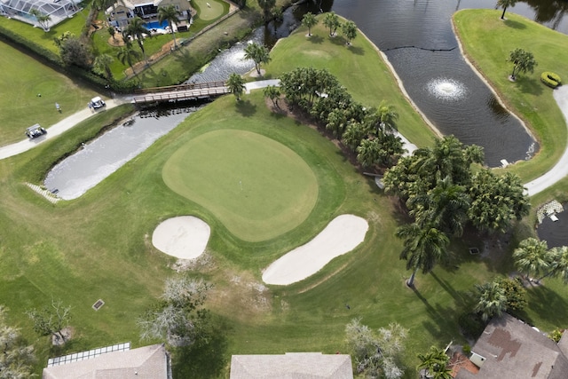 birds eye view of property featuring view of golf course and a water view