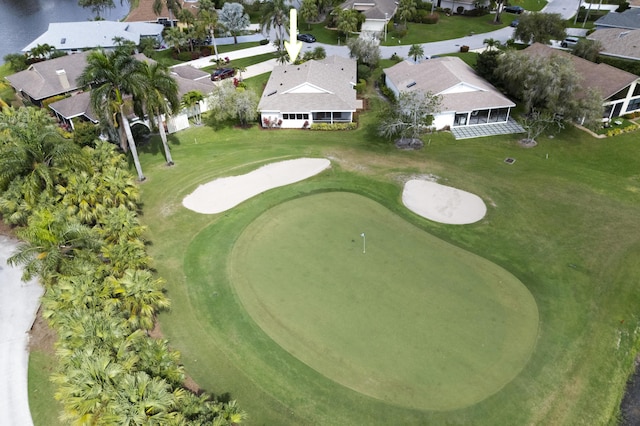 birds eye view of property with view of golf course and a residential view